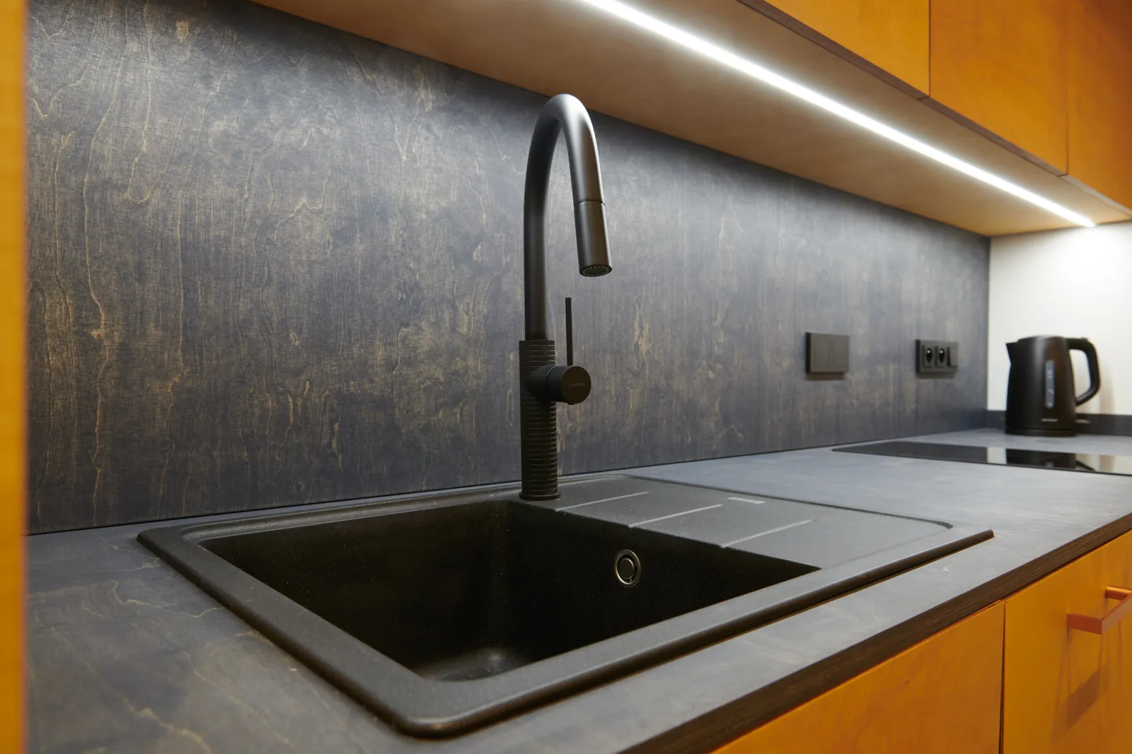 Kitchen sink mixer with pull-out spray installed in a custom kitchen