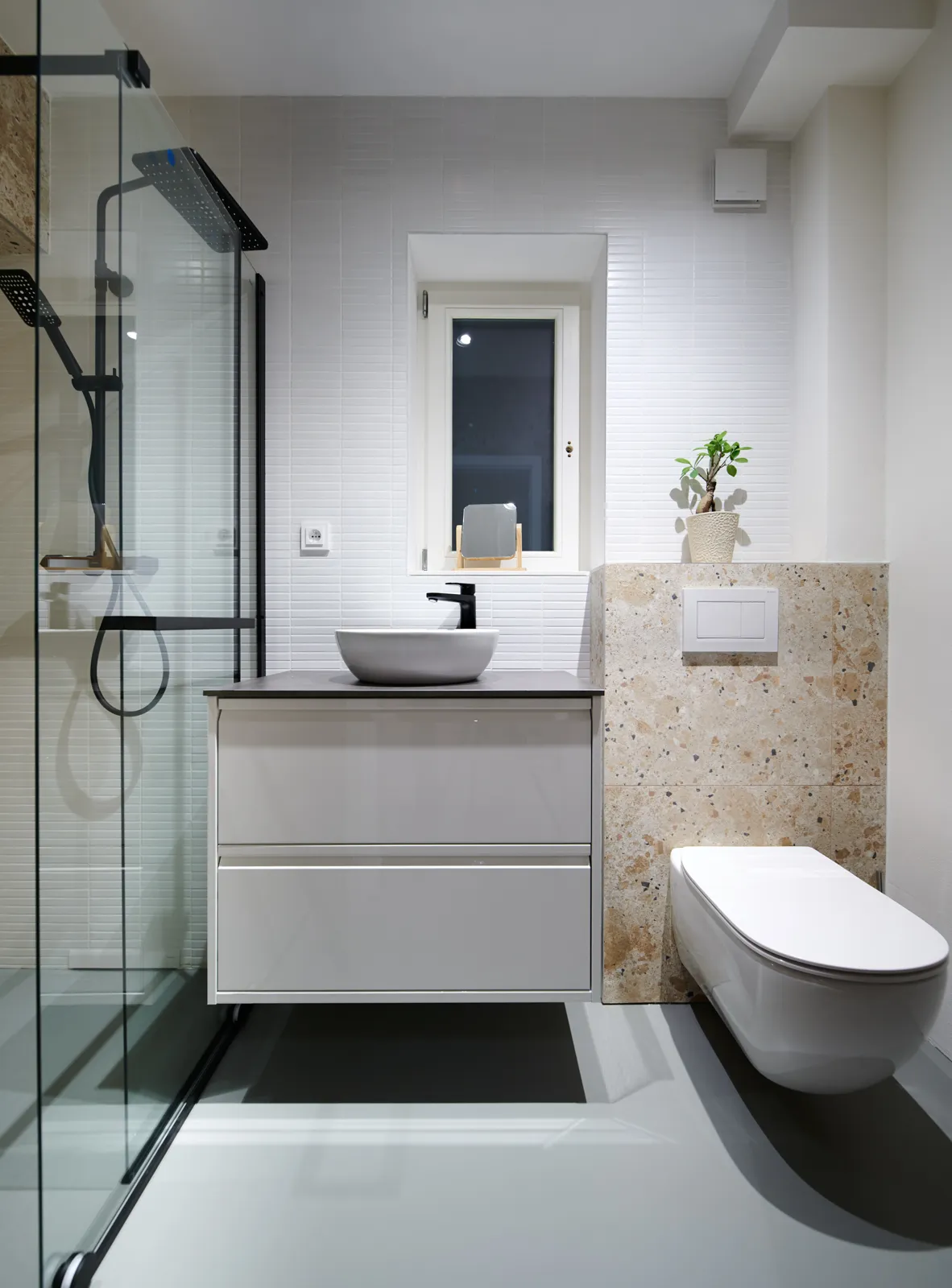 Countertop basin with a deck-mounted mixer and wall-hung vanity unit
