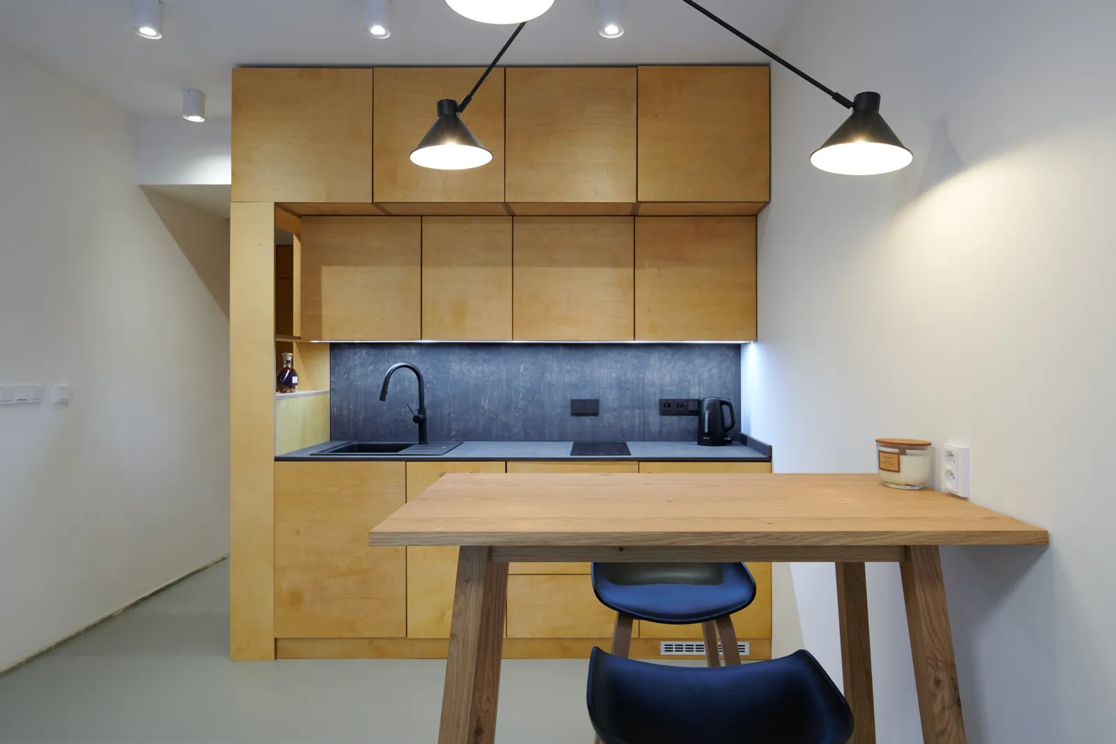 Custom birch plywood kitchen with a bar table